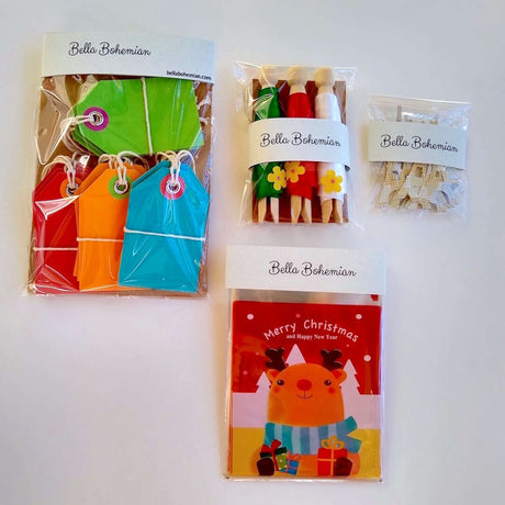 wrapped packages of Christmas favor bags, gift ribbons, gift tags and eiffel tower confetti