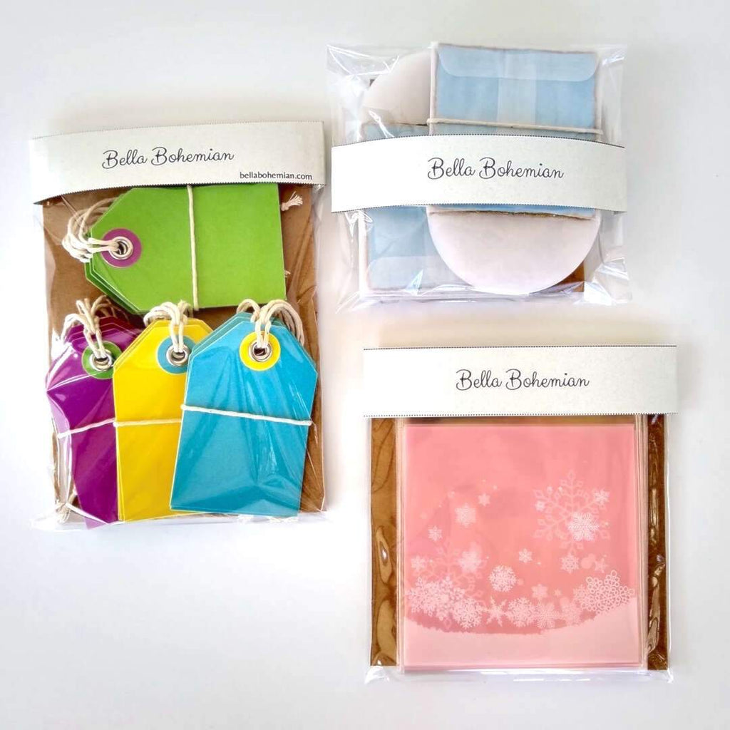 3 wrapped papeterie packs including gift tags, snowflakes favor bags, watercolor cards and glassine envelopes