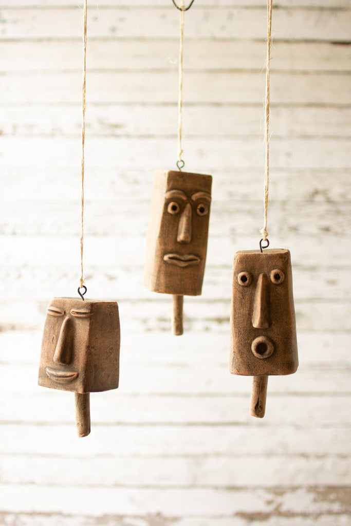 clay face hanging bells suspended with twine