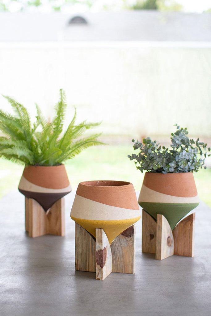 set of 3 multi-colored vases on wood bases