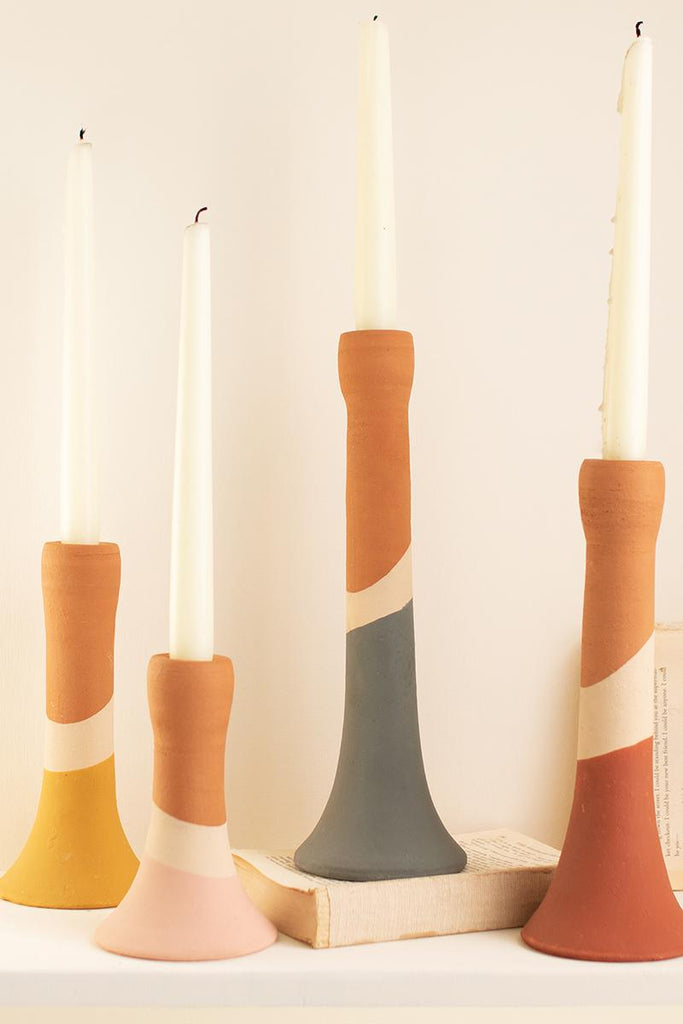 set of 3 earth tone multi-colored tapered candle holders pictured with white candles