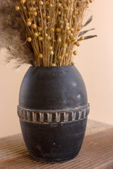 single black clay vase - zoomed in - shown with dried plants