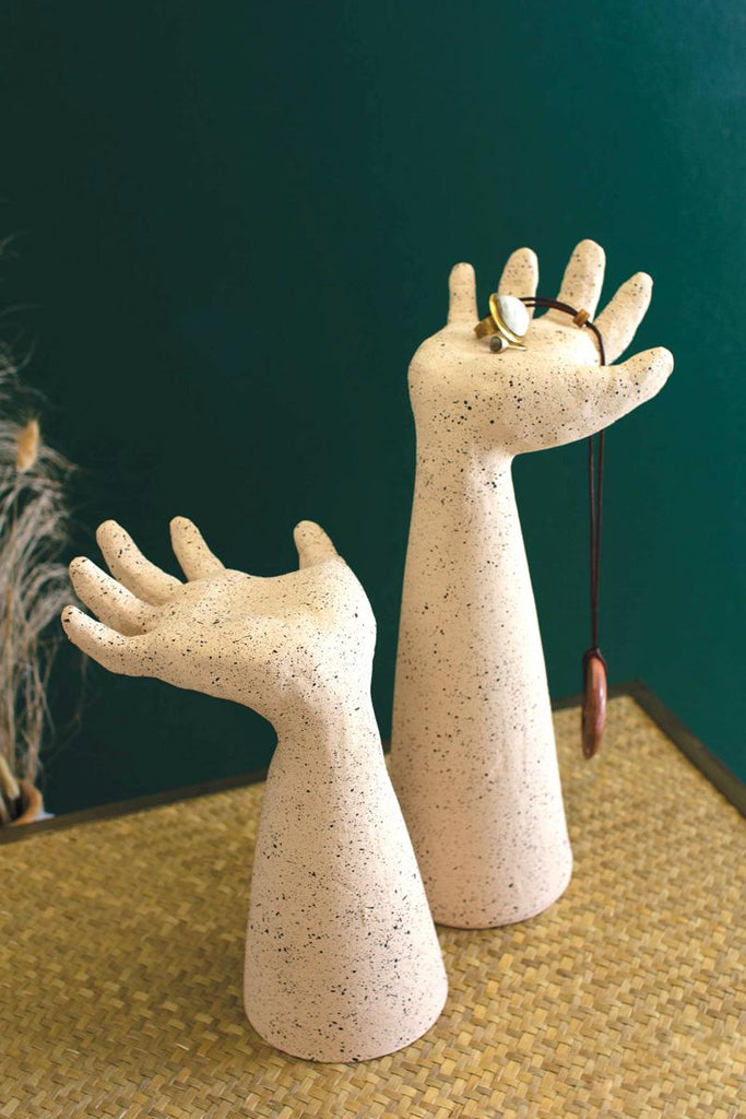 set of two clay arms with left & right hand palms facing up - shown holding a necklace