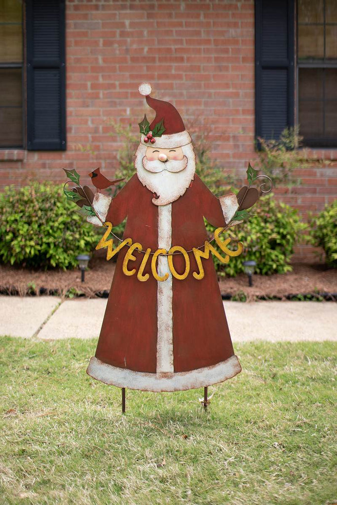 welcoming metal santa in front of brick building