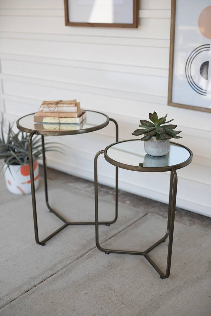 two metal side tables with glass mirror tops