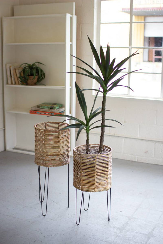 two round seagrass planters with iron legs