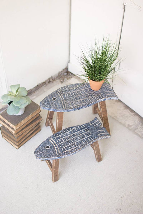 two fish shaped wooden stools