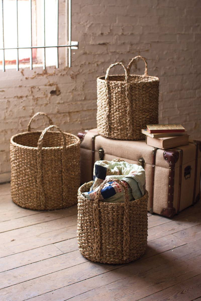 three round braided seagrass baskets with handles
