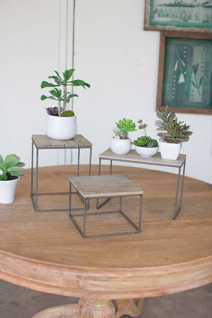 three square wood and metal table top risers