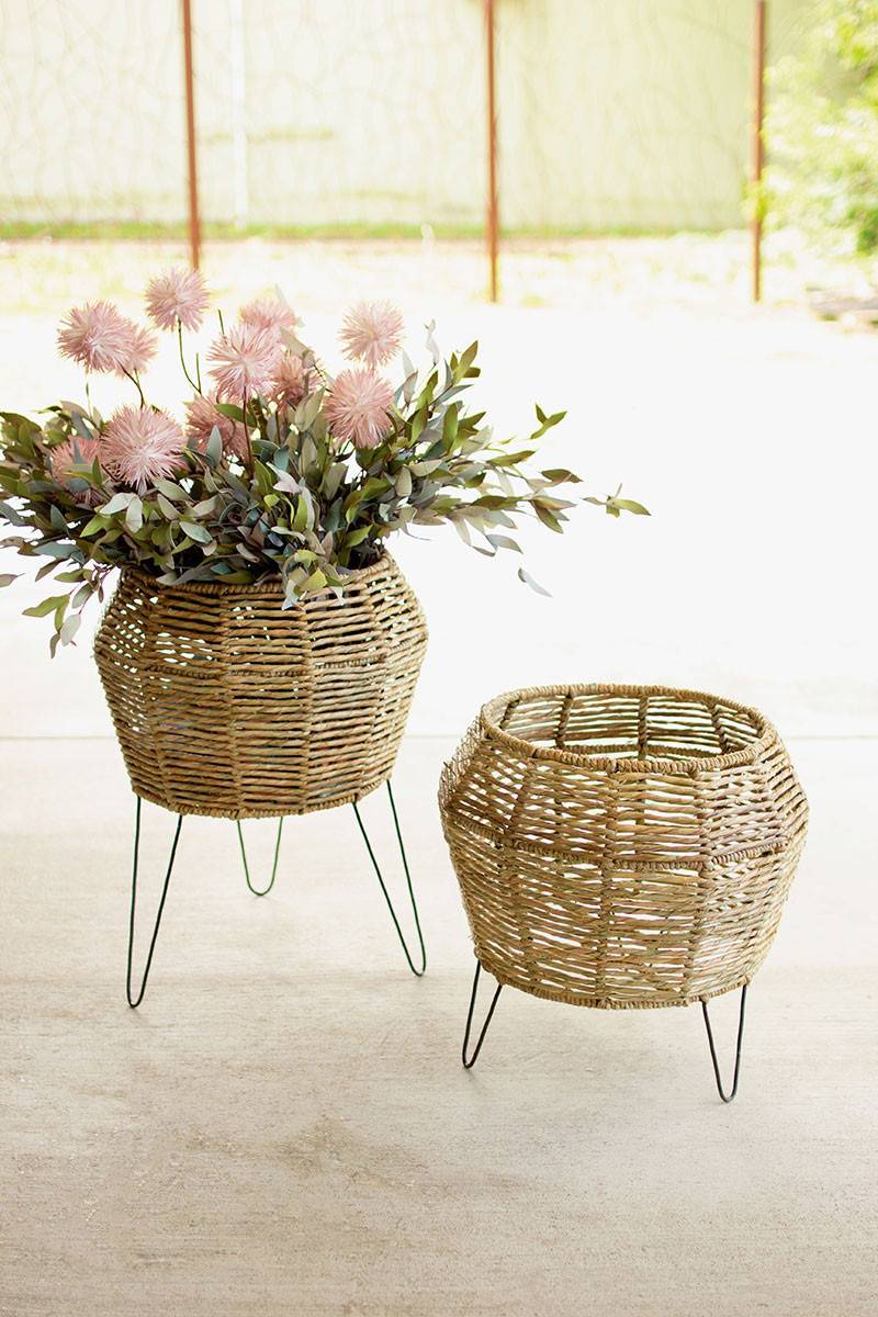 two round seagrass planters on iron legs